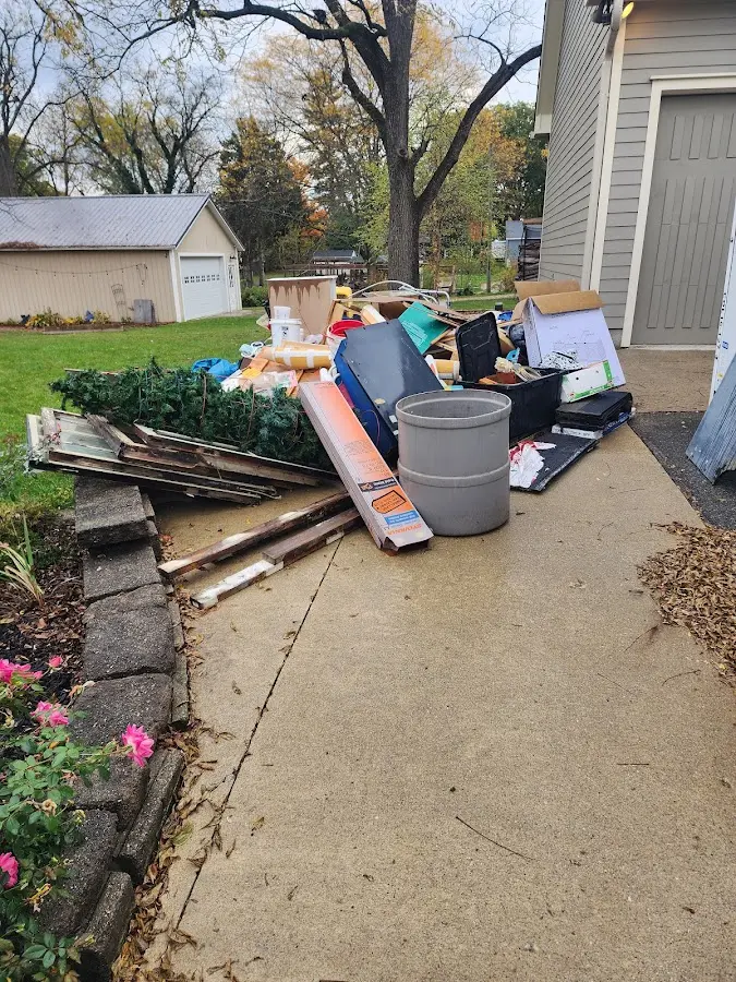 Dumpster being loaded with debris for Commercial Dumpster Rental in Adams